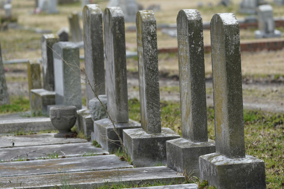 Tombstones at the Lincoln Memorial Cemetery in Portsmouth, Va., Tuesday, March 23, 2021. Many Black Americans excluded from white-owned cemeteries built their own burial spaces, and their descendants are working to preserve the grounds. Racism still haunts these cemeteries, though. Many are at risk of being lost and lack the support other cemeteries have received. (AP Photo/Steve Helber)