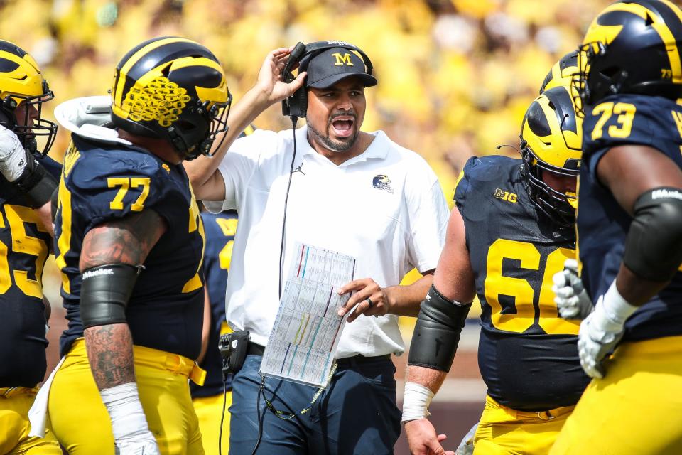 Michigan tight ends coach Grant Newsome talks to players at a timeout during the second half of U-M's 30-3 win on Saturday, Sept. 2, 2023, at Michigan Stadium.