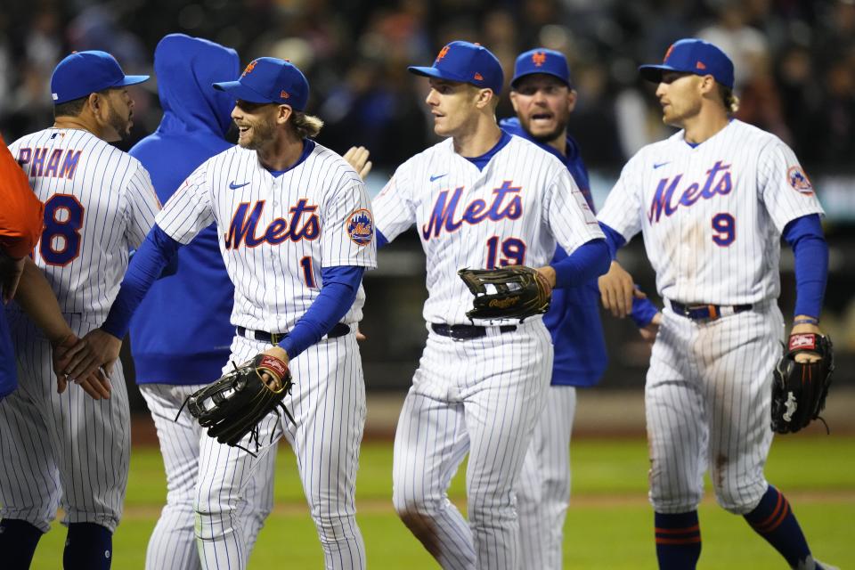 New York Mets' Jeff McNeil (1), Mark Canha (19) and Brandon Nimmo (9) celebrate with teammates after a baseball game against the San Diego Padres, Monday, April 10, 2023, in New York. The Mets won 5-0. (AP Photo/Frank Franklin II)