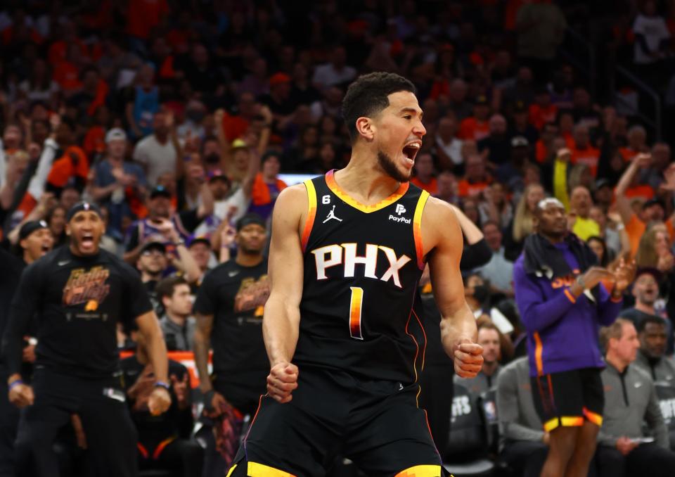 Phoenix Suns guard Devin Booker celebrates after dunking the ball against the Los Angeles Clippers in Game 5 of their playoff series at Footprint Center.