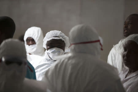 Health workers wearing protective equipment stand at the Island Clinic in Monrovia, September 30, 2014, where patients are treated for Ebola. REUTERS/Christopher Black/WHO/Handout via Reuters