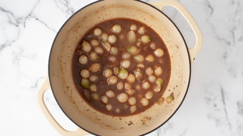 pearl onions and sauce in dutch oven