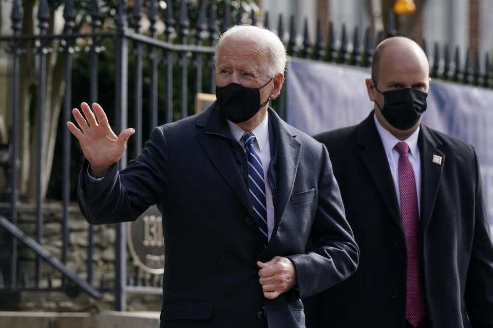 President Joe Biden waves as he departs after attending Mass at Holy Trinity Catholic Church, Sunday, Jan. 24, 2021, in the Georgetown neighborhood of Washington. (AP Photo/Patrick Semansky)