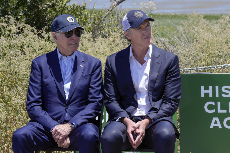 President Joe Biden sits with California Gov. Gavin Newsom as they listen to speakers during a visit to the Lucy Evans Baylands Nature Interpretive Center and Preserve in Palo Alto, Calif., Monday, June 19, 2023. (AP Photo/Susan Walsh)