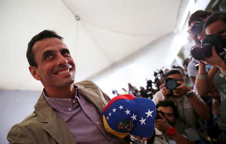 Venezuelan opposition leader Henrique Capriles smiles as he arrives for a news conference in Caracas, Venezuela, December 7, 2015. REUTERS/Nacho Doce