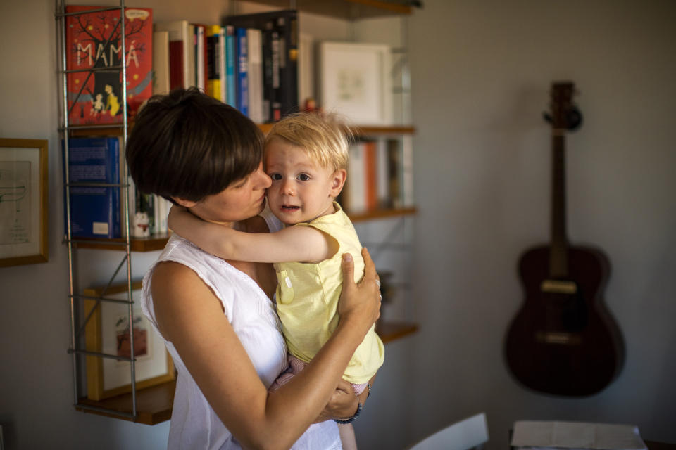 In this photo taken on Wednesday, June 19, 2019, Clara Massons holds her two years old son Jaume at her home in Barcelona, Spain. Outdated medical practices related to childbirth that continue to be used despite evidence they cause harm have come under increasing scrutiny in Europe. (AP Photo/Emilio Morenatti)