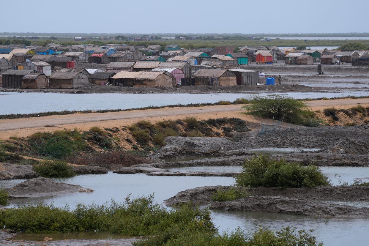 A paramilitary soldier searches an empty village to ensure everybody have been evacuated due to Cyclone Biparjoy approaching, in Keti Bandar near Thatta, Pakistan (AP)