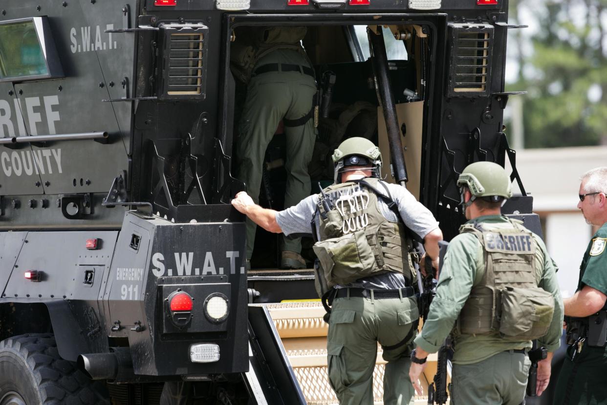 Bay County Sheriff's Office deputies enter an armored vehicle in response to an active shooter in the area: Joshua Boucher/News Herald via AP