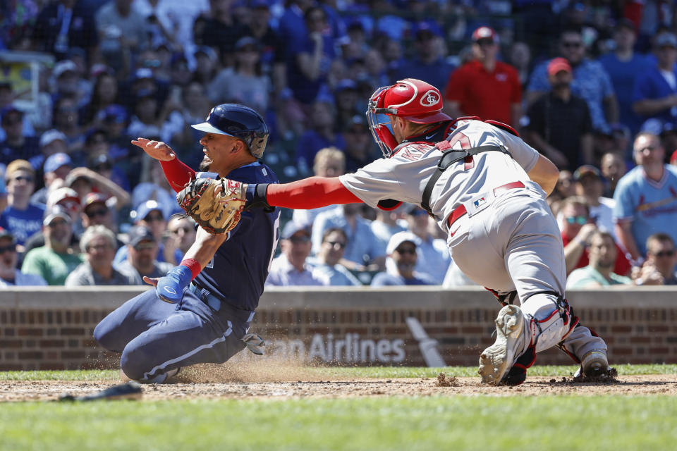 St. Louis Cardinals' Andrew Knizner, right, tags out at home plate Chicago Cubs' Rafael Ortega, left, during the fifth inning of a baseball game, Friday, June 3, 2022, in Chicago. (AP Photo/Kamil Krzaczynski)