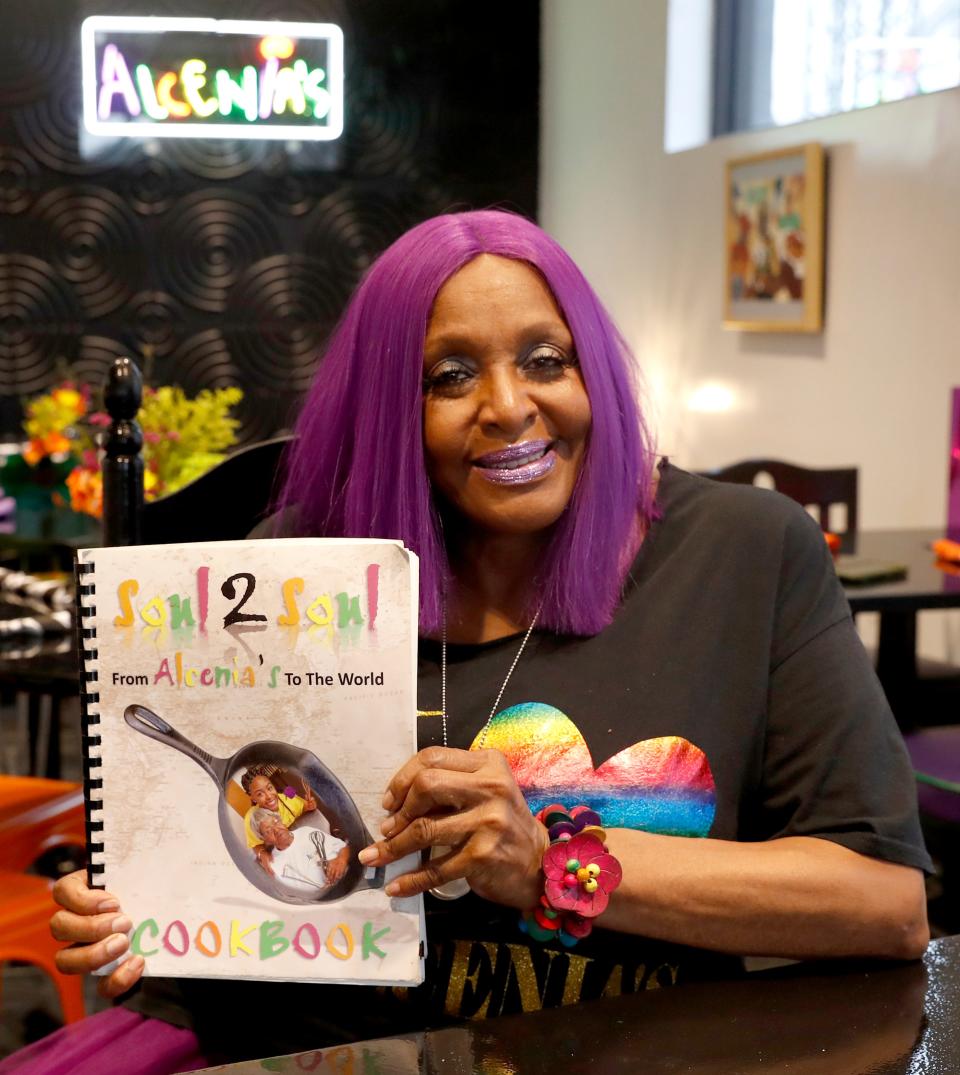 Owner  B.J. Chester-Tamayo shows her restaurant's cookbook Wednesday, April 13, 2022, at Alcenia's in Memphis.