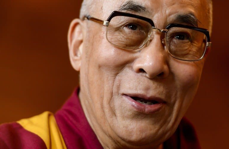 The Dalai Lama gives a press conference after visiting the Swiss House of Parliament on April 16, 2013 in Bern. Democracy champion Aung San Suu Kyi and the Dalai Lama will attend a human rights forum in Prague next month, its spokesman said
