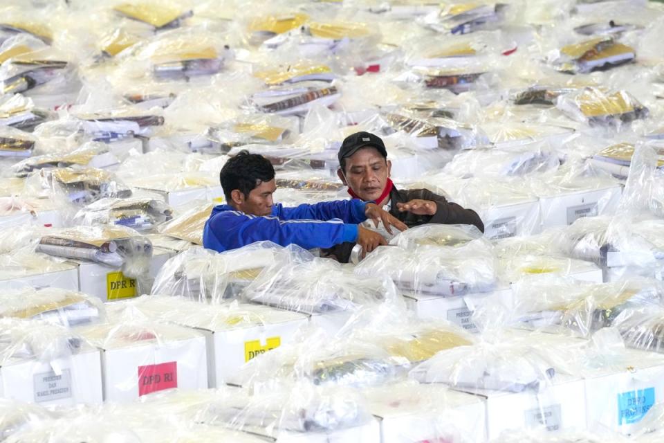 Workers prepare ballot boxes to be distributed to polling stations ahead of elections (AP)
