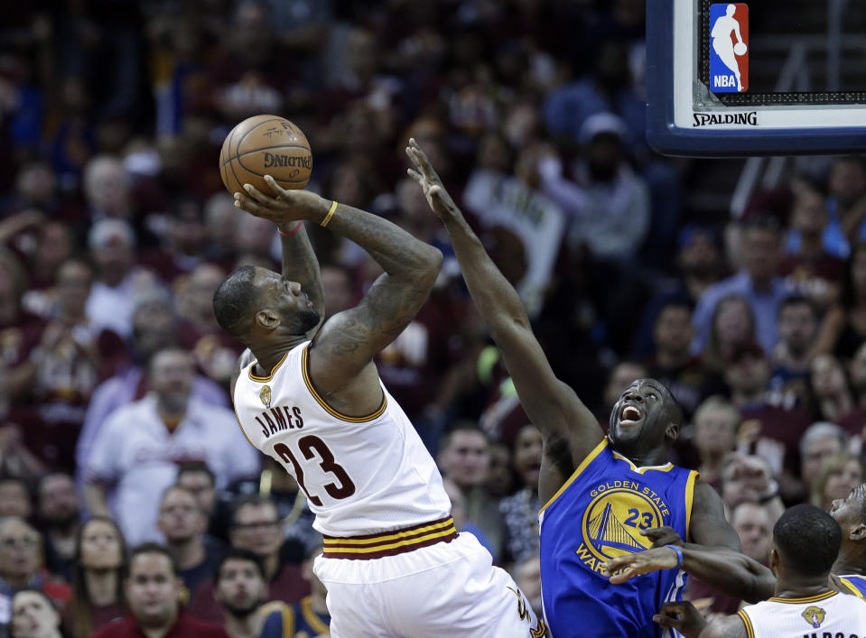 Cleveland Cavaliers forward LeBron James (23) shoots on Golden State Warriors forward Draymond Green, right, during the first half of Game 3 of basketball's NBA Finals in Cleveland, Wednesday, June 8, 2016. (AP Photo/Tony Dejak)