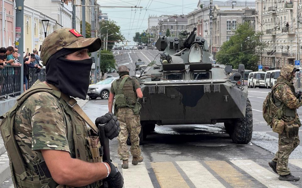 Fighters of Wagner private mercenary group stand guard in a street near the headquarters of the Southern Military District in the city of Rostov-on-Don