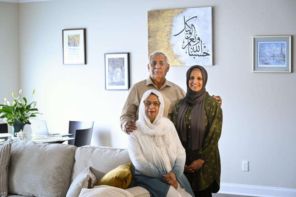 Muslim family members including daughter Saadiha, right, mother Saeeda, seated, and father Abdul Khaliq, pose in Saadiha's home Wednesday, June. 7, 2023, in Murfreesboro, Tenn. The Khaliq family are planning to travel together to Mecca in Saudi Arabia for hajj, the pilgrimage which every adult Muslim who can afford it and is physically able, must make at least once in his or her lifetime. The hajj is the fifth of the fundamental Muslim practices and institutions known as the Five Pillars of Islam. (AP Photo/John Amis)