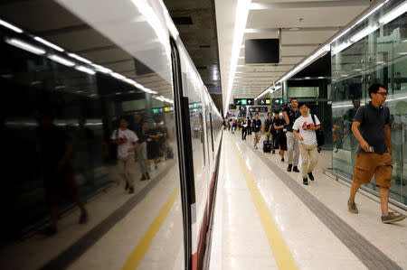 Passengers walk inside West Kowloon Terminus on the first day of service of the Hong Kong Section of the Guangzhou-Shenzhen-Hong Kong Express Rail Link, in Hong Kong, China September 23, 2018. REUTERS/Tyrone Siu