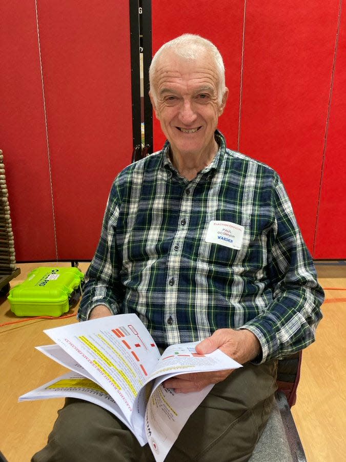 Paul O'Connor helps run the polls at St. Peter's Church in Worcester.