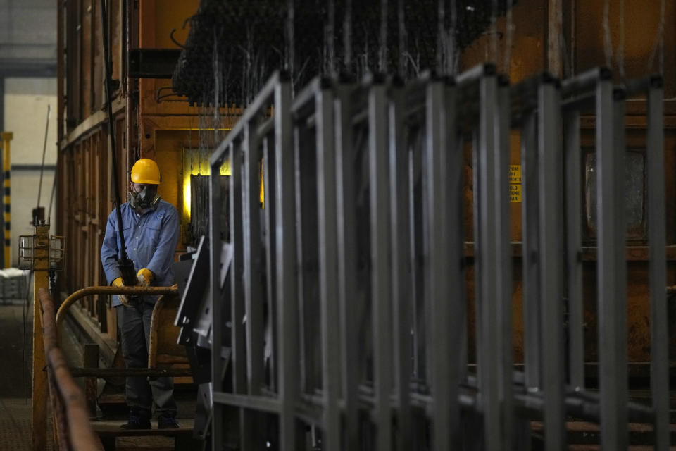 A man works in a galvanizing plant in Cambiano, northern Italy, Friday, Sept. 16, 2022. Zinc baths at Giambarini Group's galvanizing plants in northern Italy must remain super-heated around the clock, seven days a week, an energy-intensive process that has grown exponentially more costly as gas prices spike. The energy crisis facing Italian industry and households is a top voter concern going into Sunday's parliamentary elections as fears grow that astronomically high bills will shutter some businesses and force household rationing by winter. (AP Photo/Antonio Calanni)