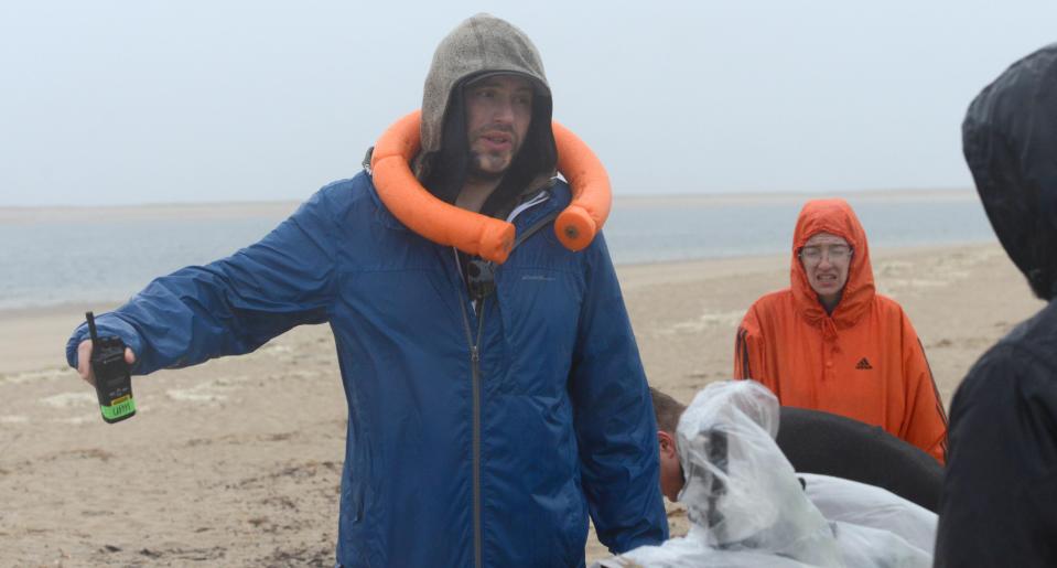 Director Matt Ott ended up with a clam basket float around his neck at the end of shooting a scene of a short film in driving rain Tuesday at Lighthouse Beach in Chatham.