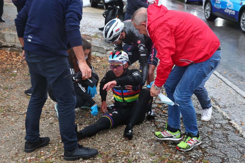 <span class="article__caption">Remco Evenepoel is assisted by members of his team after crashing during the fifth stage of the Giro d’Italia. (LUCA BETTINI/AFP via Getty Images)</span>