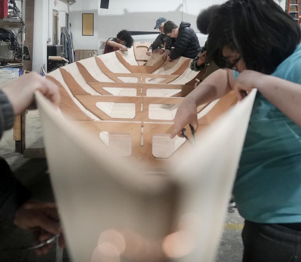 Paul Bargren and students cut the wires during the hands-on educational experience building a boat Monday, Feb. 5, 2024, at All Hands Boatworks in Milwaukee.