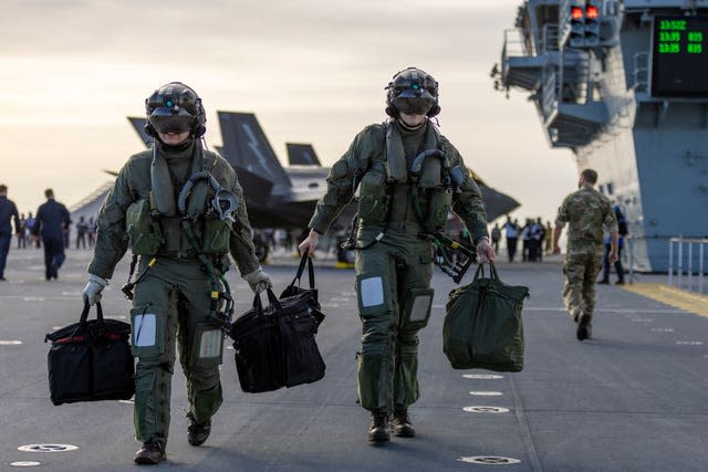 Pilots of F-35B Lightning jets on the flight deck of HMS Prince of Wales