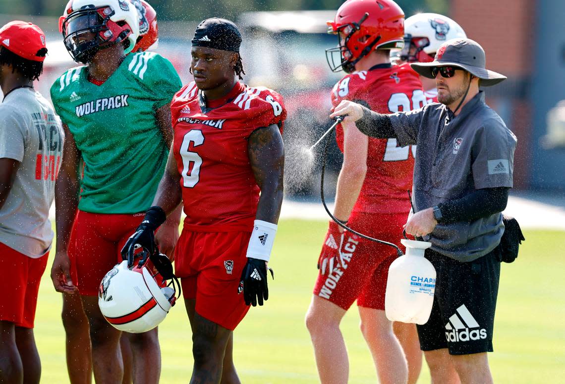 N.C. State safety Jakeen Harris (6) is cooled down during the Wolfpack’s first practice of fall camp in Raleigh, N.C., Wednesday, August 3, 2022.