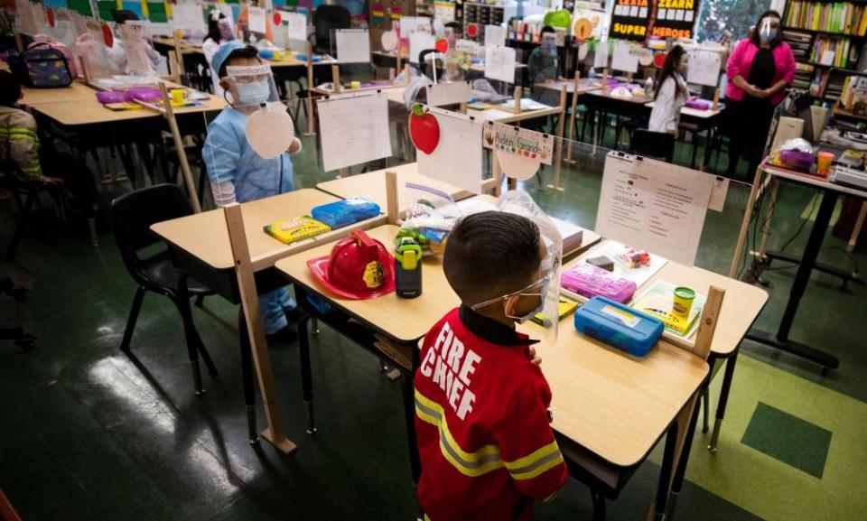 Kindergarten students wearing face shields and masks