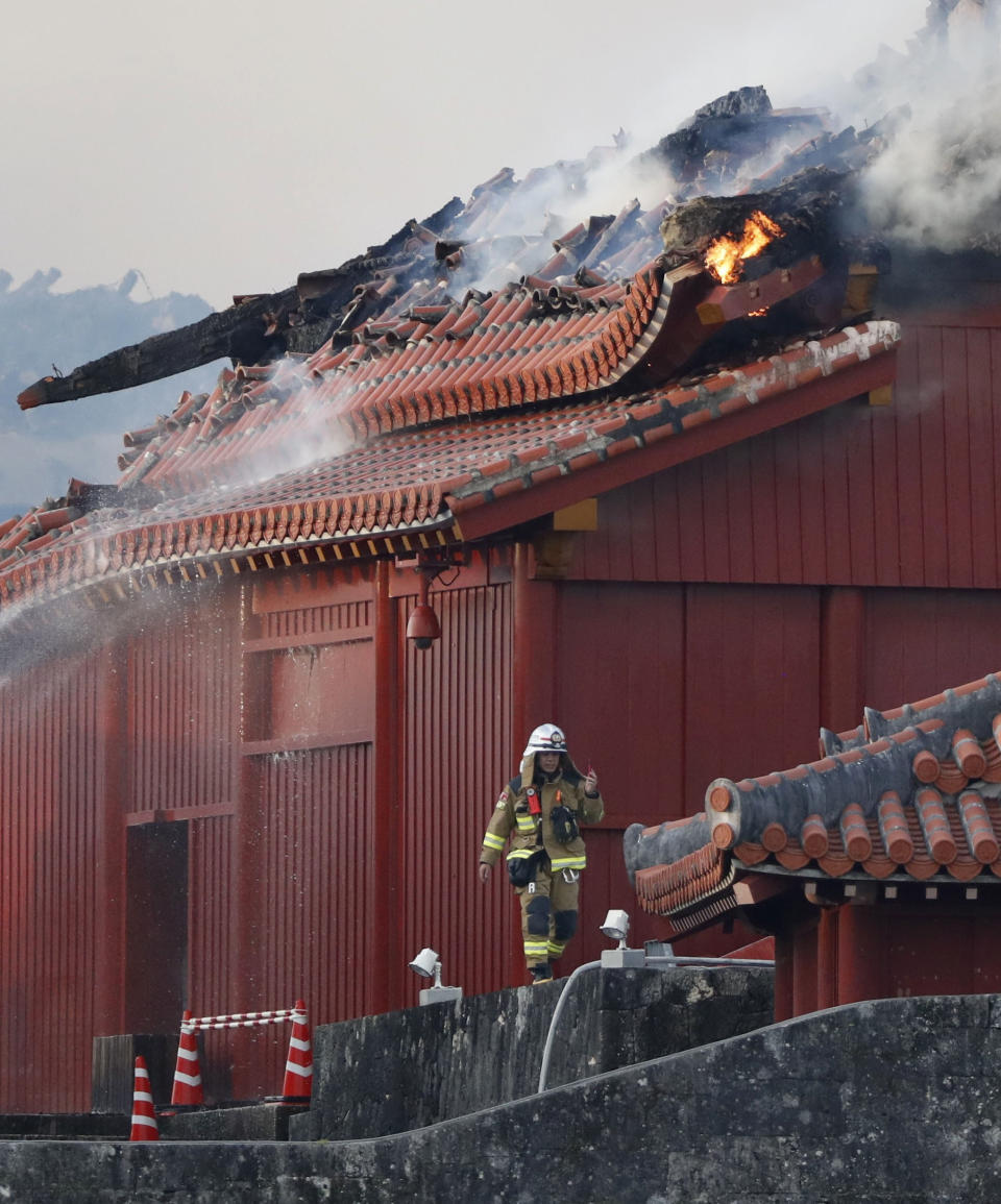 A firefighter works in front of the burning north hall of Shuri Castle in Naha, Okinawa, southern Japan, Thursday, Oct. 31, 2019. A fire spread among structures at Shuri Castle on Japan's southern island of Okinawa, nearly destroying the UNESCO World Heritage site. (Jun Hirata/Kyodo News via AP)