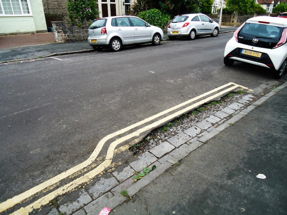 Instead of repairing the pothole, council staff painted lines around it(Picture: SWNS)