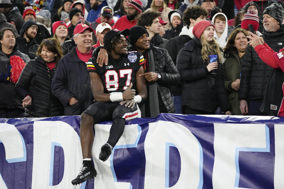 Maryland wide receiver Robert Smith (87) celebrates the team's 31-13 win against Auburn after the Music City Bowl NCAA college football game with fans Saturday, Dec. 30, 2023, in Nashville, Tenn. (AP Photo/George Walker IV)