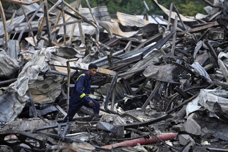 A firefighter moves among burnt debris the day after a fire broke out in an amusement park in Rajkot, India, Sunday, May 26, 2024. A massive fire damaged a large part of the park on Saturday, killing more than twenty people and injuring some others, news reports said. (AP Photo/Ajit Solanki)