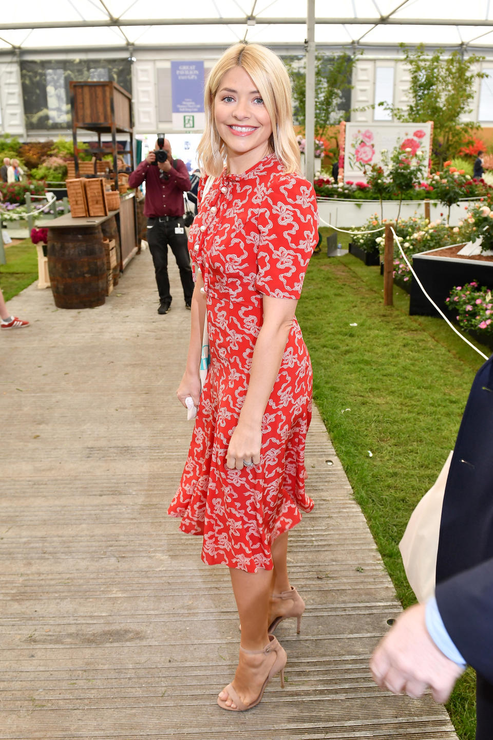 <p>The Morning presenter Holly Willoughby looked typically gorgeous as she attended the Chelsea Flower Show in a red L.K.Bennett tea dress, worn with nude heels. <br>[Photo: Getty] </p>