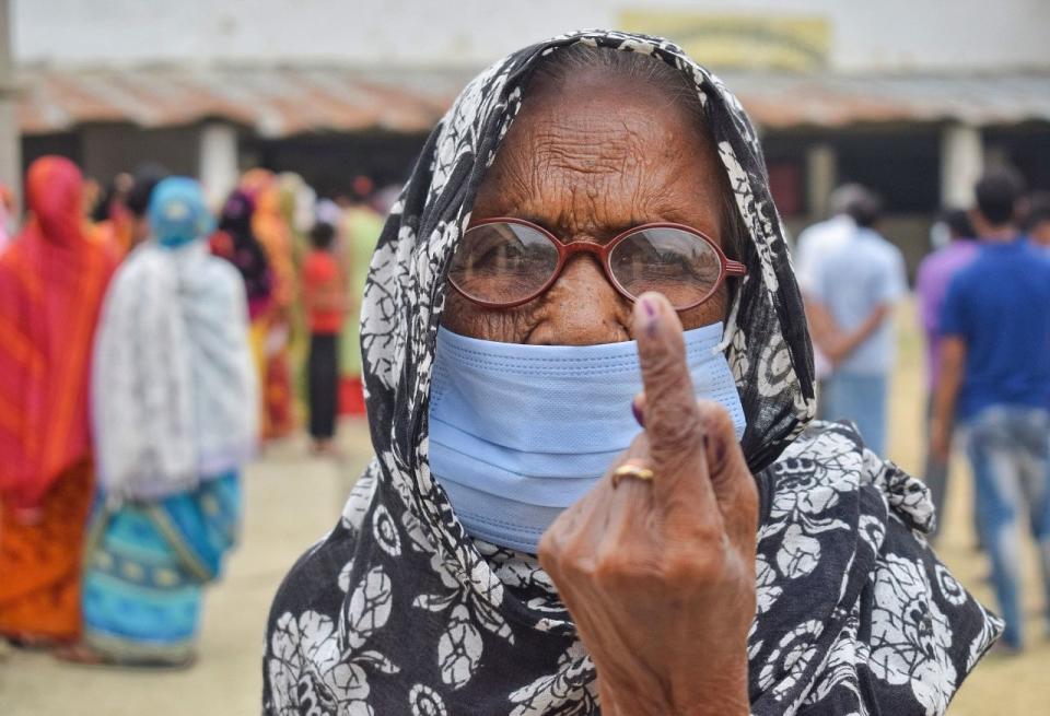 An elderly woman being brought at a polling booth to cast her vote for the 6th phase of West Bengal Assembly polls, in Nadia.