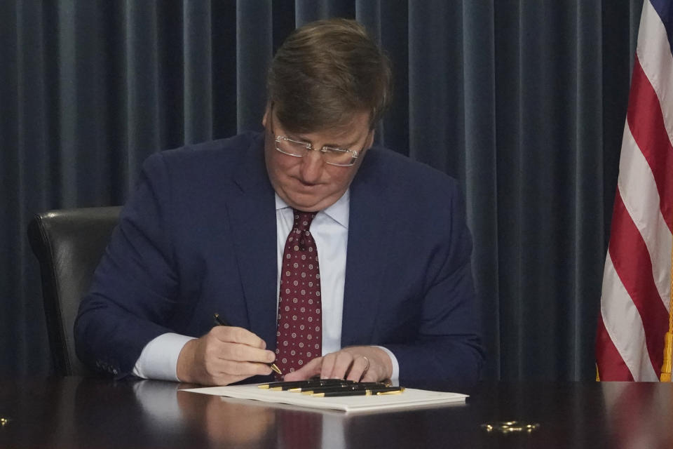 FILE - Mississippi Republican Gov. Tate Reeves signs Mississippi House Bill 1125, to ban gender-affirming care in the state for anyone younger than 18, during a news conference, Tuesday, Feb. 28, 2023, in Jackson, Miss. The sponsor of the bill denied in a conversation with Associated Press reporters this year that he used model legislation or consulted with a specific group, saying that his constituents raised concerns and that legislative attorneys helped craft the language. (AP Photo/Rogelio V. Solis, File)