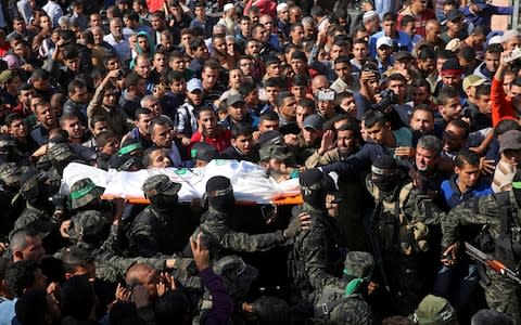 Mourners carry the body of Hamas militant commander Nour el-Deen Barakas, who was killed during the Israeli raid - Credit: Adel Hana/ AP