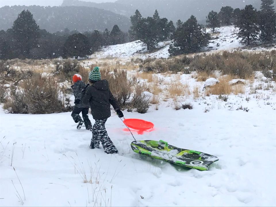 Kids enjoy the fresh snow near Pine Valley in Washington County on Wednesday.