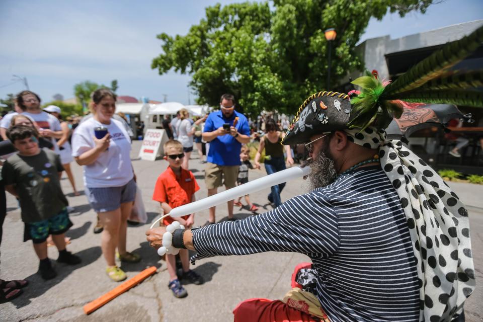 Joseph Hodges makes balloon animals for kids at the 2022 Paseo Art Festival in Oklahoma City.
