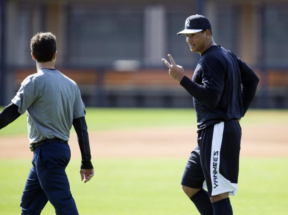 New York Yankees' Alex Rodriguez (R) talks with a trainer at the Yankees minor league complex for spring training in Tampa, Florida February 23, 2015. REUTERS/Scott Audette (UNITED STATES - Tags: SPORT BASEBALL)