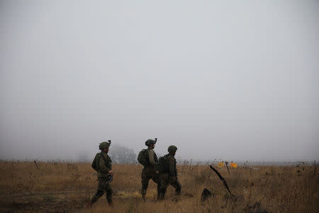 Israeli soldiers patrol the area where Syrians cross the armistice line from Syria to the Israeli-occupied Golan Heights to get medical treatment in Israel, July 11, 2018. REUTERS/Ronen Zvulun