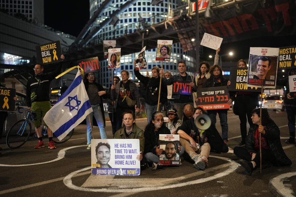 People block a street during a protest calling for a deal to release the hostages held in the Gaza Strip by the Hamas militant group, in Tel Aviv, Israel, Thursday, Feb. 29, 2024. (AP Photo/Ohad Zwigenberg)