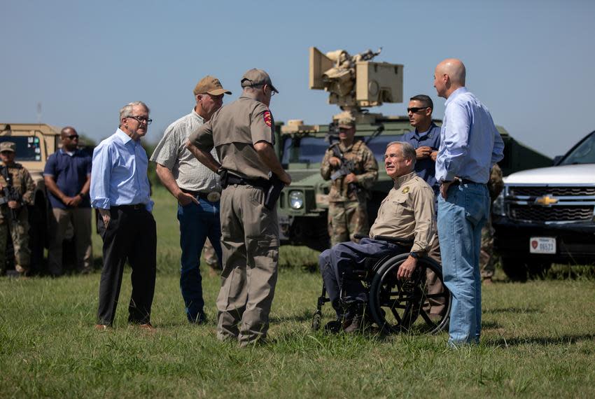 Flanked by National Guard members, Gov. Greg Abbott spoke with Texas Department of Public Safety Director Steve McCraw before an October press conference in Mission.