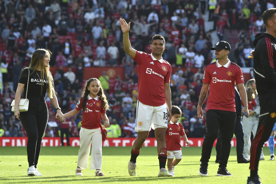 Manchester United's Casemiro leaves the pitch with his family at the end of the English Premier League soccer match between Manchester United and Fulham at Old Trafford in Manchester, England, Sunday, May 28, 2023. (AP Photo/Rui Vieira)