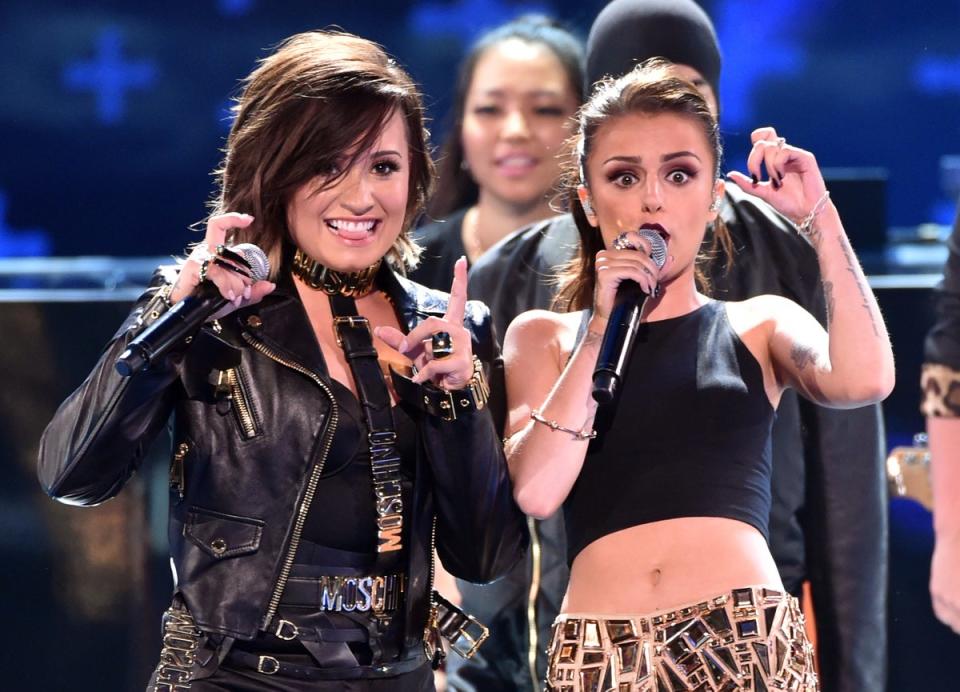 Recording artists Demi Lovato (L) and Cher Lloyd perform onstage during FOX's 2014 Teen Choice Awards (Getty Images)
