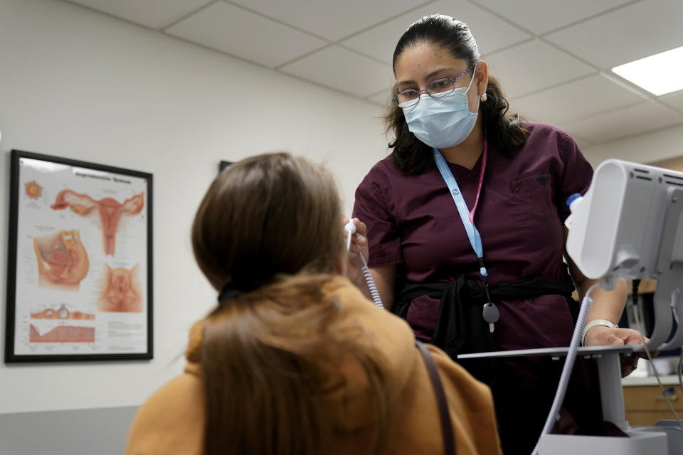 Amy Perez examines Haley Ruark during Ruark's medical abortion visit at a Planned Parenthood clinic Wednesday, Oct. 12, 2022, in Kansas City, Kan. (AP Photo/Charlie Riedel)