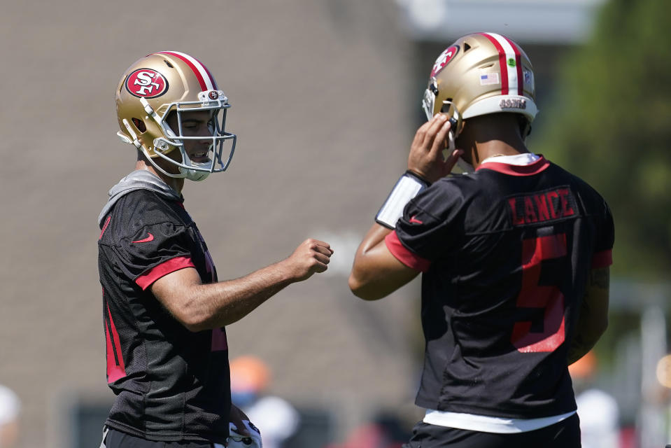 San Francisco 49ers quarterback Jimmy Garoppolo, left, fist bumps quarterback Trey Lance as they take part in drills at the NFL football team's practice facility in Santa Clara, Calif., Thursday, Sept. 1, 2022. (AP Photo/Jeff Chiu)