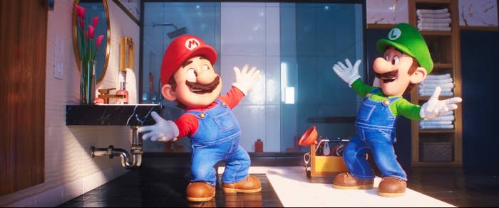 Mario and Luigi celebrate with arms outstretched in the bathroom during their first plumbing job