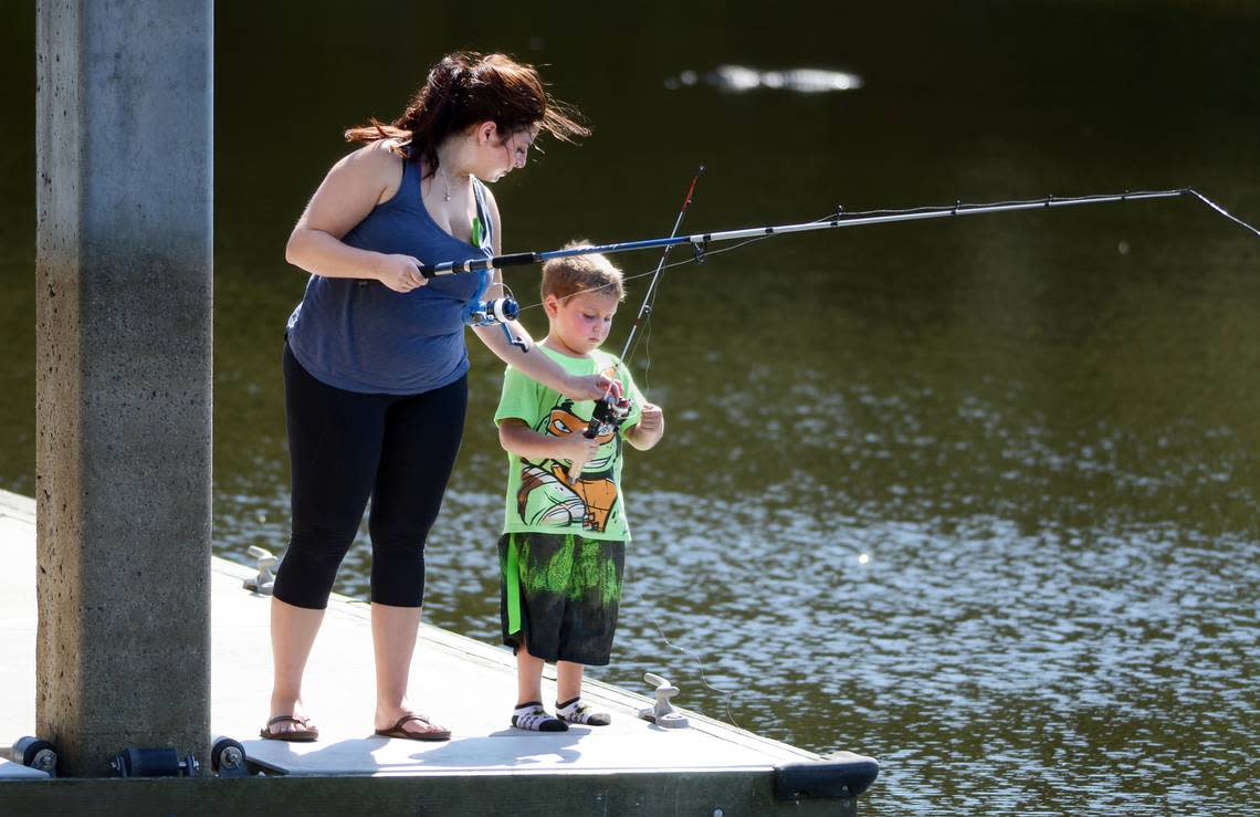 Hilton Head Islander Celeste Iannazzo helps her son Rocco, 5, untangle the line on his new pole while fishing from the dock at Jarvis Creek Park on Monday. “We didn’t catch any fish, but we caught a turtle,” said Celeste of the after-school outing. Jay Karr