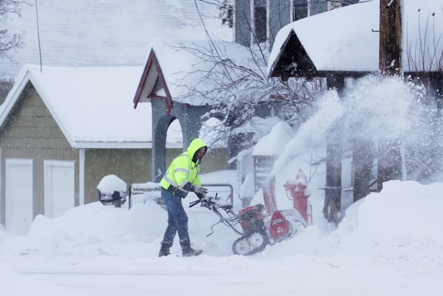 Snow is cleared from a sidewalk during a storm, Sunday, March 3, 2024, in Truckee, Calif. (AP Photo/Brooke Hess-Homeier)