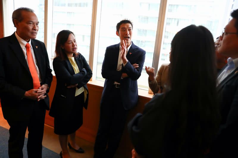 Thailand's opposition Future Forward Party leader Thanathorn Juangroongruangkit speaks with his party members before hearing the verdict from the Constitutional Court at the party headquarters in Bangkok